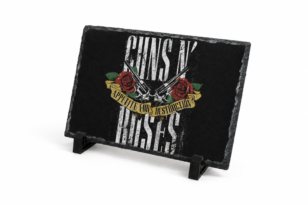 A rectangular black slate sign on a small black stand, featuring Guns N' Roses artwork with distressed white lettering, red roses, and a gold banner on a white background.