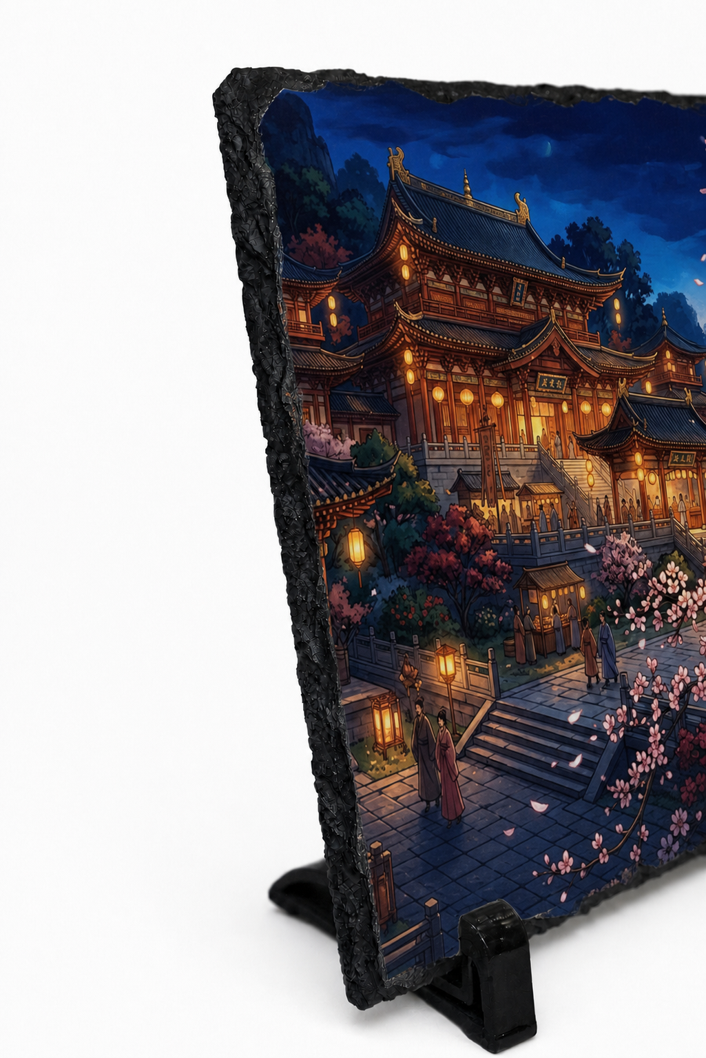 A rectangular slate sign with a black textured border, standing on a black easel against a white background. The sign features a detailed digital painting of a traditional East Asian temple complex at night, illuminated by warm golden lanterns under a dark blue sky.