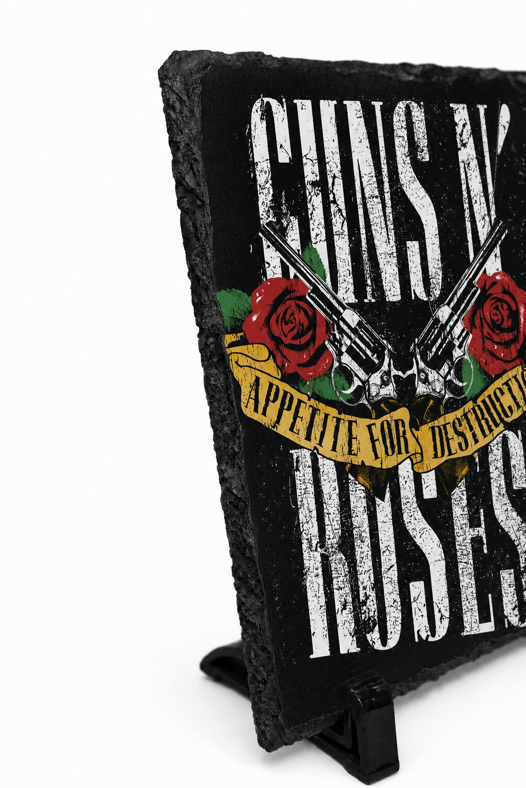 A black slate sign featuring the Guns N' Roses logo with distressed white lettering, red roses, crossed silver pistols, and a yellow banner reading 'Appetite for Destruction,' displayed on a small black stand against a white background.