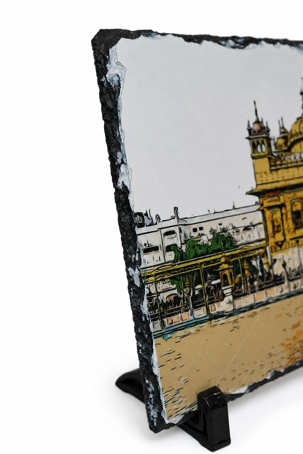 A square black slate art print on a black display stand, featuring a stylized illustration of the Golden Temple in Amritsar with yellow, white, green, and blue details.