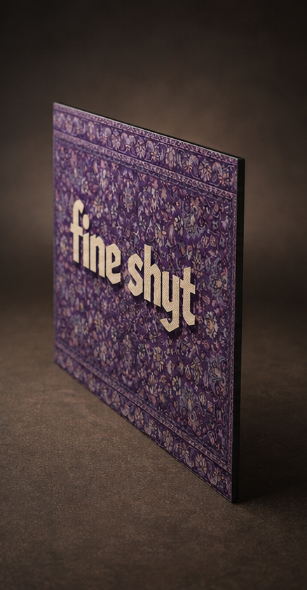 A purple patterned rectangular box or package standing upright on a dark brown surface, with the words 'fine shyt' raised in light beige letters on the front.